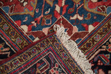 Vintage Heriz carpet corner showing the full pile, hand-knotted back, and original side cord.