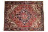 Vintage Mehrivan carpet with a bursting geometric medallion in rust red, navy blue, and ivory.
