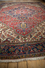 Low-angle view along a vintage Mehrivan carpet showing the plush, colorful geometric pattern.