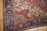 Corner of a vintage Mehrivan carpet showing the navy border, full pile, and original side selvage.