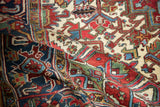 A soft fold highlights the plush pile and saturated geometric floral motifs of a vintage Mehrivan carpet.