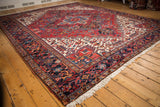 Dense, full pile of a vintage Persian Heriz rug viewed from a low corner angle.