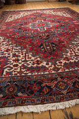 Angled view of a vintage Heriz carpet showcasing its full pile and concentric medallion design.