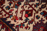 Plush hand-knotted wool pile with cherry red and navy blue vinery.