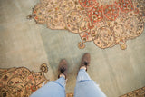 Vintage Tabriz rug detail: curvilinear floral spandrel with tendrils on abrashed powder blue field.