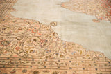 Intricate floral corner spandrel detailing on a powder blue field of a vintage Tabriz.