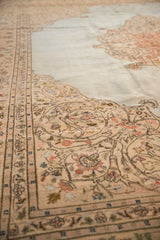 Vintage Persian Tabriz rug with beige border, scrolling floral tendrils, and powder blue field.