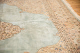 Soft powder blue abrashed field and beige curvilinear spandrel of a vintage Tabriz carpet.
