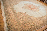 Vintage Tabriz carpet corner with powder blue field, scrolling floral spandrel, and fringe.