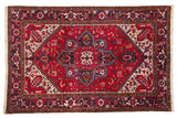 Vintage Persian Mehrivan carpet with a geometric quatrefoil medallion in cherry red, navy, and ivory.