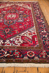 Full pile height and intact side cord selvage on a vintage Persian Mehrivan carpet corner.
