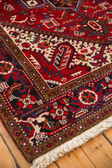 Angled close-up of a vintage Mehrivan carpet corner, showing the dense pile, ivory fringe, and traditional border.