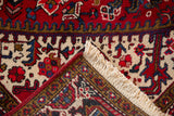 Folded corner of a vintage Mehrivan carpet showing its hand-knotted back and full pile.