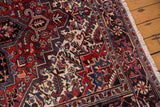 Original ivory fringe and deep blue-red border patterns of a vintage Mehrivan carpet.
