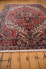 Intact ivory fringe and section of vintage Mehrivan rug's red and navy patterned border.