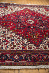 Angled view down the cherry red field, highlighting the plush pile of a vintage Mehrivan rug.