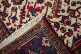 Corner of a vintage Mehrivan rug showing the hand-knotted back, intact side cord, and full ivory pile.