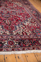 Close view of the intricate geometric border and floral field on a vintage Mehrivan carpet.
