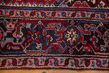Classic turtle and meandering vine design in the hand-knotted main border of a vintage carpet.