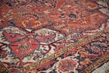 Intricate Samovar Turtle border and scrolling vinery on a full-piled vintage Persian Heriz carpet.