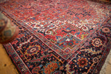 Vintage Persian Heriz corner with a dense, full pile and a navy blue floral and vine main border.