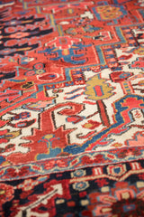 Dense, full wool pile of a vintage Heriz carpet showing geometric floral patterns.