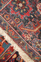 Dense wool pile, intact side cord selvage, and clean ivory fringe on a vintage Heriz carpet.