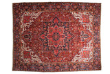 Vintage Ahar carpet with a geometric Heriz-style medallion in ruby red, sapphire blue, and ivory.