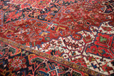 Close-up of the vintage Ahar rug's brilliant gem shades and curvilinear floral design.