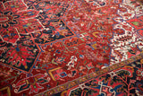 Saturated ruby and sapphire hues in the dense wool pile of a vintage Persian Ahar carpet.