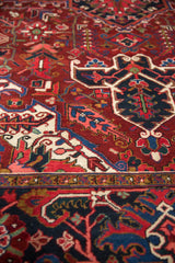 Close-up on the plush pile of a vintage Ahar carpet with gem-toned floral motifs.
