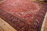 Full pile and intricate navy floral border on the corner of a vintage Persian Heriz carpet.