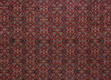Detailed view of the finely woven Herati motif in sapphire blue on a cherry red field.