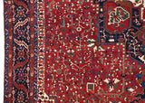 Intricate geometric vinery and serrated leaf border of a fine Persian Karaja collector rug.