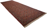 Angled view of a vintage Tabriz runner with a Herati field and reciprocating turtle border.