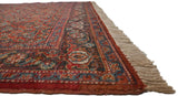 A collector Tabriz carpet corner, showing the detailed turtle design border and thick beige fringe.