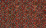Detailed view of the Herati motif on a vintage Tabriz carpet in brick red, blue, and mallard green.