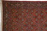 Corner of a vintage Tabriz carpet showing the intact selvage, fringe, and reciprocating turtle design border.