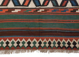 Detail of the handwoven reciprocating pawn border and striped color bands on an antique Persian kilim.