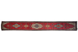 Antique Karabagh runner with central medallions and bird motifs on an abrashed cherry red field.