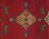 Stylized green birds face a central geometric medallion on the antique Karabagh rug's cherry red field.