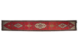 Antique Karabagh runner with central medallions and bird figures on a rich abrashed red field.