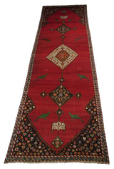 Angled view of an antique Karabagh runner with facing bird motifs and a column of center medallions.