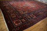 Joshegan carpet corner, featuring meandering palmette borders and a pawn motif in deep red and indigo.