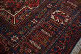 Joshegan carpet corner, brick red and sapphire blue borders with pawn motif, and fringe.