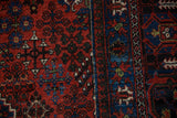 Joshegan carpet detail: brick red field, sapphire blue floral designs, and pawn motif border.