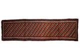 Antique Kurdish rug runner with diagonal channels of wine red, cobalt blue, gold, and ivory.