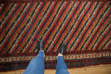 Overhead view of an antique Kurdish runner's intricate diagonal pattern and bold pawn motif border.