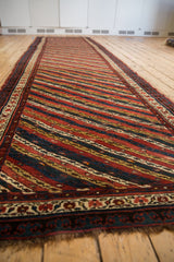 Low angle perspective of the antique Kurdish runner's colorful, diagonally oriented vine and channel design.