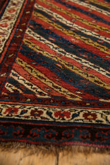 Close-up showing the pawn motif border and diagonal vine channels of an antique Kurdish runner.